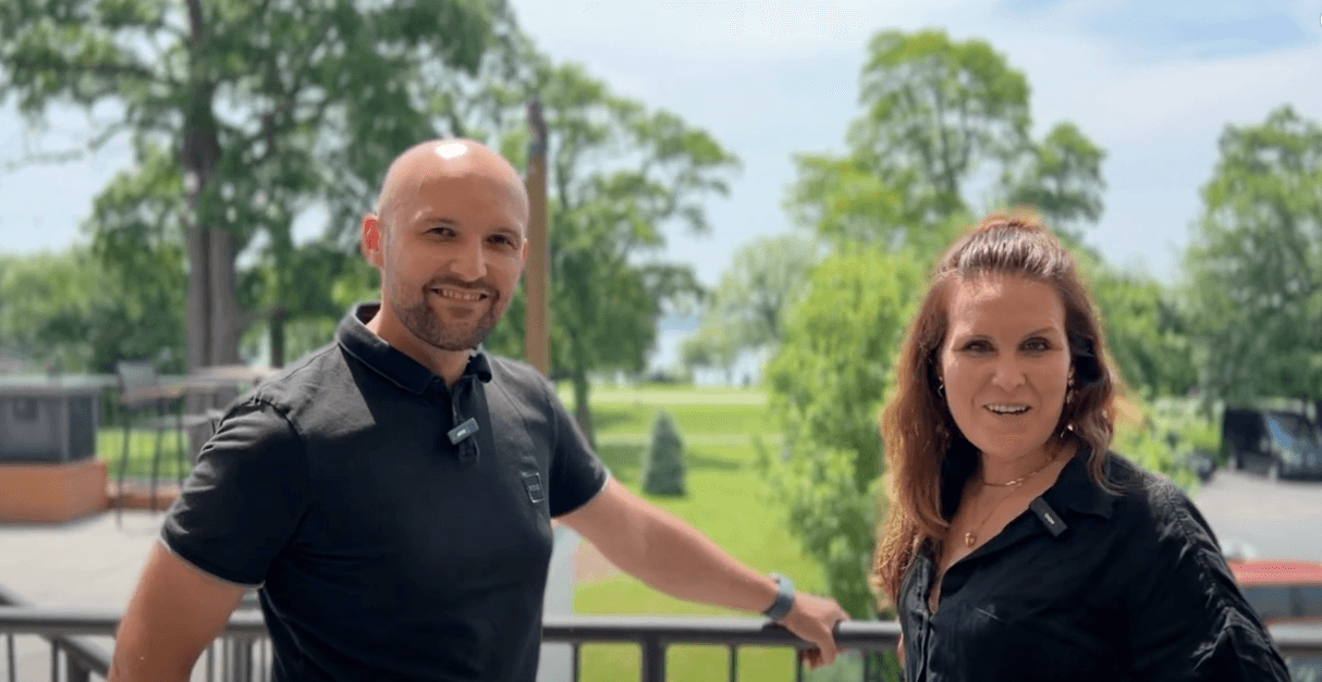 Djordje Savija of ZoomRide Health and an iCabbi interviewer on a balcony overlooking trees and a lawn